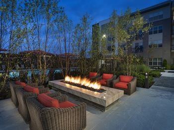Expansive lawn with lounge seating that includes games and dual fireplace